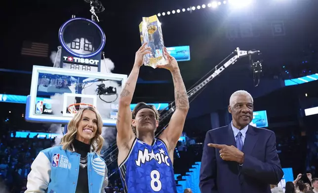 Orlando Magic guard Mac McClung, center, celebrates with Julius Erving, right, after winning the slam dunk contest at the NBA basketball All-Star Saturday night festivities Saturday, Feb. 15, 2025, in San Francisco. (AP Photo/Godofredo A. Vásquez)