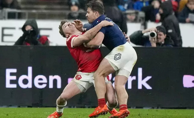 France's Antoine Dupont, right, tries to get to the line during the Six Nations rugby union match between France and Wales at the Stade de France in Saint-Denis, outside Paris, Friday, Jan. 31, 2025. (AP Photo/Michel Euler)