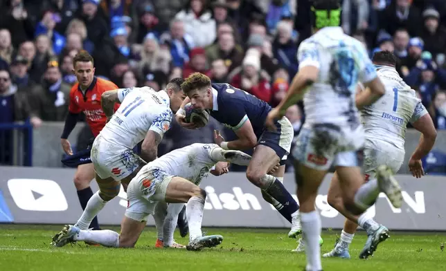 Scotland's Huw Jones on his way to scoring his third try during the Six Nations rugby union match between Scotland and Italy, at Murrayfield Stadium, Edinburgh, Scotland, Saturday Feb. 1, 2025. (Andrew Milligan/PA via AP)