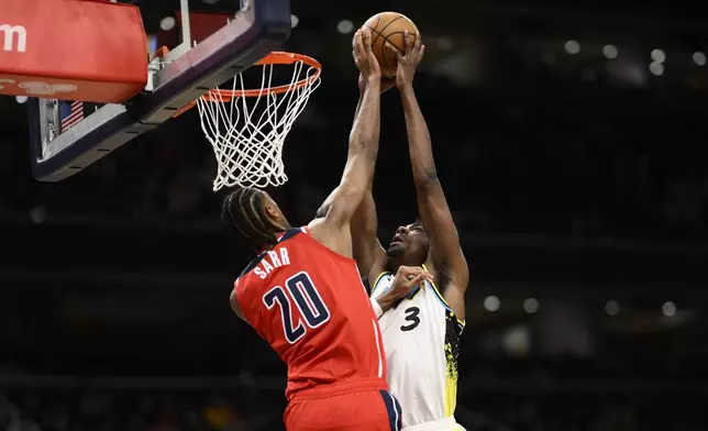 Washington Wizards forward Alex Sarr (20) blocks Indiana Pacers center Thomas Bryant (3) during the first half of an NBA basketball game, Wednesday, Feb. 12, 2025, in Washington. (AP Photo/Nick Wass)