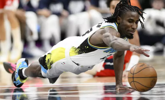 Indiana Pacers forward Aaron Nesmith reaches for the ball during the first half of an NBA basketball game against the Washington Wizards, Wednesday, Feb. 12, 2025, in Washington. (AP Photo/Nick Wass)