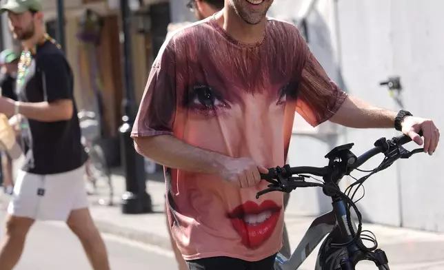 A person wearing a Taylor Swift shirt walks in the French Quarter before the NFL Super Bowl 59 football game between the Kansas City Chiefs and the Philadelphia Eagles, Sunday, Feb. 9, 2025, in New Orleans. (AP Photo/Julia Demaree Nikhinson)