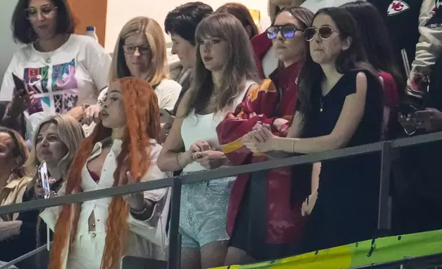 Ice Spice, from left, Taylor Swift, Este Haim and Alana Haim watch during the first half of the NFL Super Bowl 59 football game between the Kansas City Chiefs and the Philadelphia Eagles, Sunday, Feb. 9, 2025, in New Orleans. (AP Photo/Gerald Herbert)