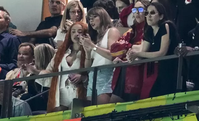 Ice Spice, from left, Taylor Swift, Este Haim and Alana Haim watch during the first half of the NFL Super Bowl 59 football game between the Kansas City Chiefs and the Philadelphia Eagles, Sunday, Feb. 9, 2025, in New Orleans. (AP Photo/Gerald Herbert)