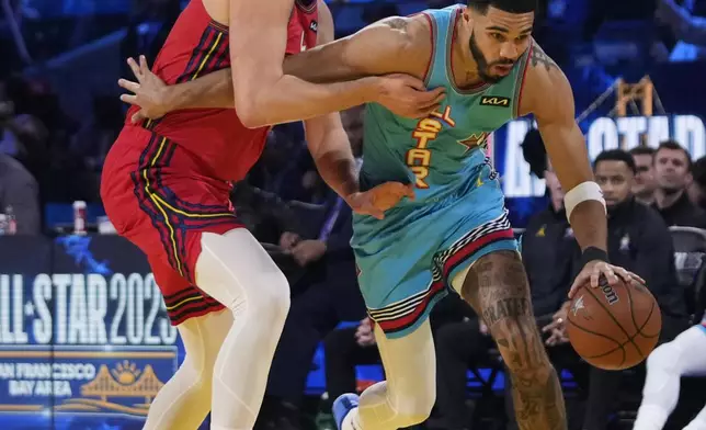 Boston Celtics guard Jayson Tatum dribbles past Denver Nuggets center Nikola Jokic during the NBA All-Star basketball game Sunday, Feb. 16, 2025, in San Francisco. (AP Photo/Godofredo A. Vásquez)