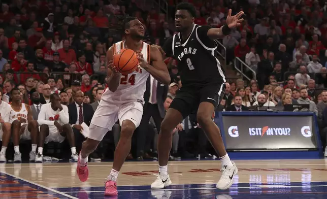 St. John's forward Zuby Ejiofor (24) dribbles the ball against Providence forward Christ Essandoko (2) during the second half of an NCAA college basketball game Saturday, Feb. 1, 2025, in New York. (AP Photo/Pamela Smith)