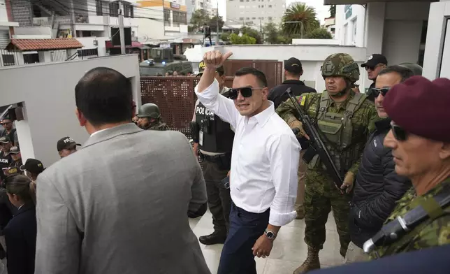 Ecuador's President Daniel Noboa, running for re-election, waves after accompanying his running mate, Maria Jose Pinto, to cast her ballot during the presidential elections in Quito, Ecuador, Sunday, Feb. 9, 2025. (AP Photo/Carlos Noriega)