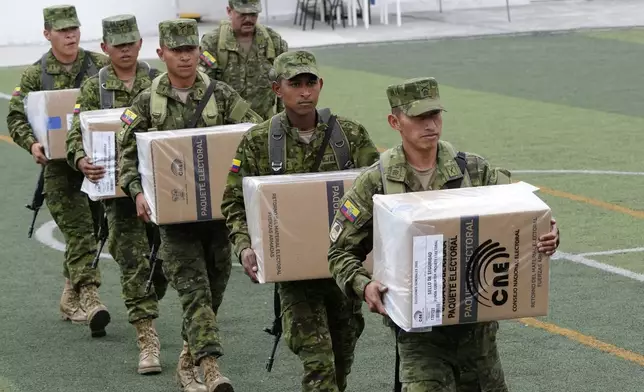 Soldiers unload election materials at a polling station in preparation for Sunday's general election, in Quito, Ecuador, Saturday, Feb. 8, 2025. (AP Photo/Dolores Ochoa)