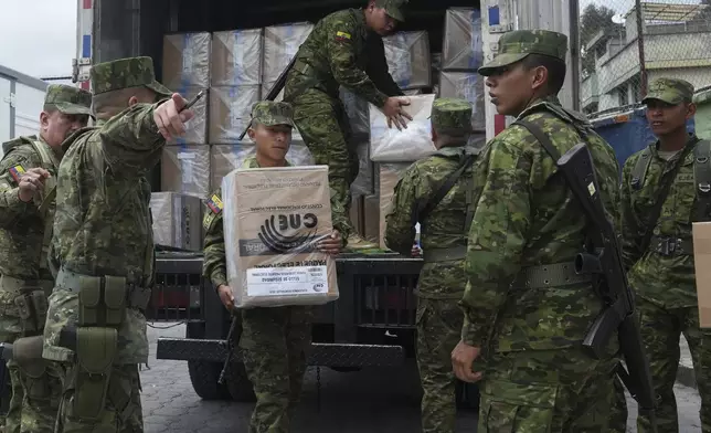 Soldiers unload election materials at a polling station in preparation for Sunday's general election, in Quito, Ecuador, Saturday, Feb. 8, 2025. (AP Photo/Dolores Ochoa)