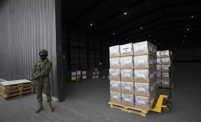A soldier stands guard at a distribution center of electoral kits ahead of Sunday's general election, in Quito, Ecuador, Saturday, Feb. 8, 2025. (AP Photo/Dolores Ochoa)