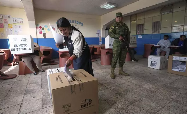 A voter casts her ballot during the presidential election in Quito, Ecuador, Sunday, Feb. 9, 2025. (AP Photo/Dolores Ochoa)