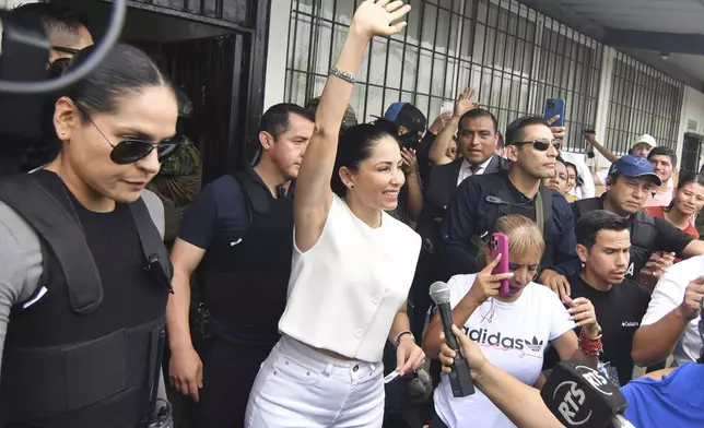 Luisa Gonzalez, presidential candidate for the Citizen Revolution Movement, waves after voting in a presidential election in Canuto, Ecuador, Sunday, Feb. 9, 2025. (AP Photo/Jairo Mendoza)