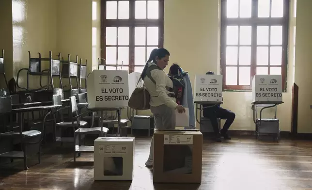 A woman votes during presidential elections in Quito, Ecuador, Sunday, Feb. 9, 2025. (AP Photo/Carlos Noriega)