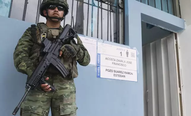 A soldier guards a polling station during presidential elections in Olon, Ecuador, Sunday, Feb. 9, 2025. (AP Photo/Cesar Munoz)