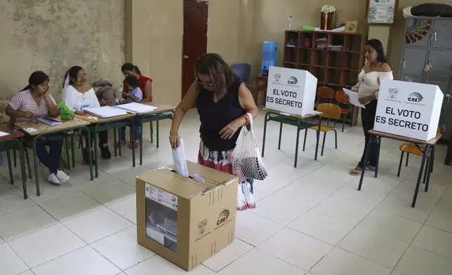 A voter cast her ballot during presidential elections in Olon, Ecuador, Sunday, Feb. 9, 2025. (AP Photo/Cesar Munoz)
