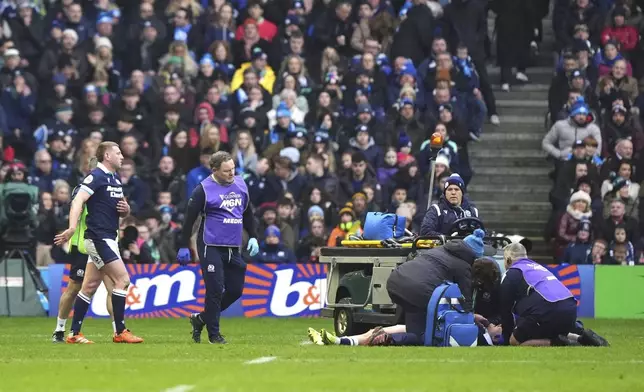 Scotland's Finn Russell, left, and Scotland's Darcy Graham, right, leave the field during the Six Nations match between Scotland and Ireland at Murrayfield Stadium, Edinburgh, Sunday Feb. 9, 2025. (Andrew Milligan/PA via AP)