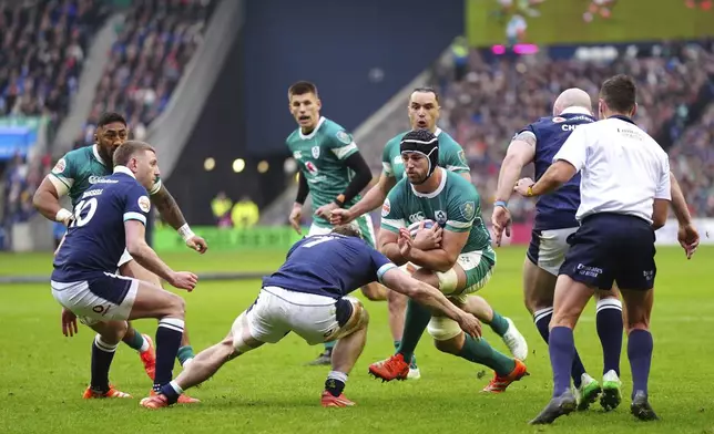Ireland's Caelan Doris is tackled by Scotland's Rory Darge during the Six Nations match between Scotland and Ireland at Murrayfield Stadium, Edinburgh, Sunday Feb. 9, 2025. (Jane Barlow/PA via AP)