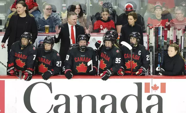 Canada head coach Troy Ryan speaks to his players on the bench during the first period of a women's Rivalry Series hockey game in Halifax, Nova Scotia, Thursday, Feb. 6, 2025. (Darren Calabrese/The Canadian Press via AP)