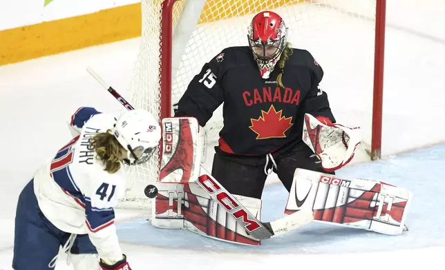 Canada goaltender Ann-Renee Desbiens, right, makes a save as United States' Maureen Murphy, left, looks for a rebound during the third period of a women's Rivalry Series hockey game in Halifax, Nova Scotia, Thursday, Feb. 6, 2025. (Darren Calabrese/The Canadian Press via AP)