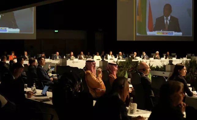Delegates watch South Africa's President Cyril Ramaphosa addressing them at the G20 Finance Ministers and Central Bank Governors meeting in Cape Town, South Africa, Wednesday, Feb. 26, 2025. (AP Photo/Nardus Engelbrecht)