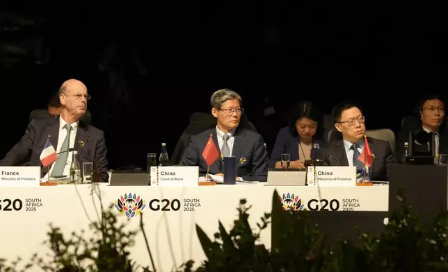 French Finance Minister Eric Lombard, left, with Xuan Changneng, Deputy Governor with the People's Bank of China, center, attend the G20 Finance Ministers and Central Bank Governors meeting in Cape Town, South Africa, Wednesday, Feb. 26, 2025. (AP Photo/Nardus Engelbrecht)