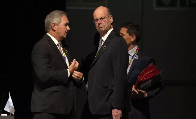 French Finance Minister Eric Lombard, right, chats with a fellow delegate at the G20 Finance Ministers and Central Bank Governors meeting in Cape Town, South Africa, Wednesday, Feb. 26, 2025. (AP Photo/Nardus Engelbrecht)
