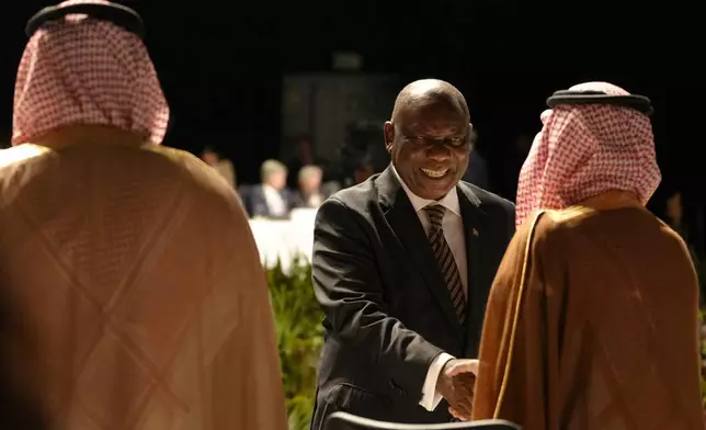 South Africa's President Cyril Ramaphosa, center, greets delegates at G20 Finance Ministers and Central Bank Governors meeting in Cape Town, South Africa, Wednesday, Feb. 26, 2025. (AP Photo/Nardus Engelbrecht)