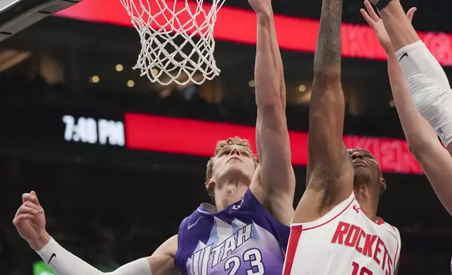 Houston Rockets forward Jabari Smith Jr. (10) and Utah Jazz forward Lauri Markkanen (23) try to rebound during the first half of an NBA basketball game Saturday, Feb. 22, 2025, in Salt Lake City. (AP Photo/Bethany Baker)