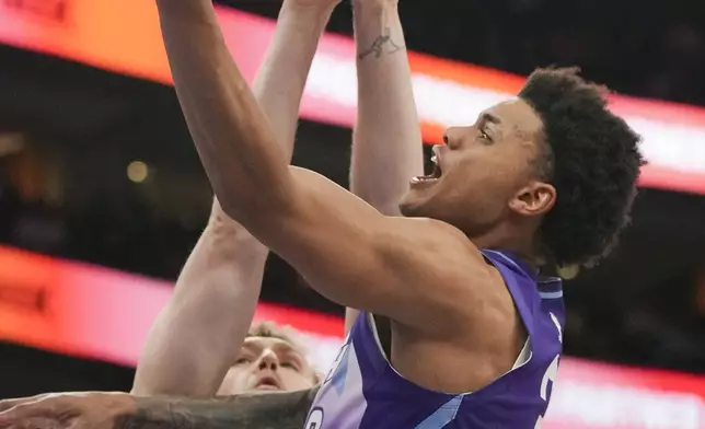 Houston Rockets center Jock Landale (2) blocks as Utah Jazz guard Keyonte George (3) goes for a layup during the first half of an NBA basketball game Saturday, Feb. 22, 2025, in Salt Lake City. (AP Photo/Bethany Baker)