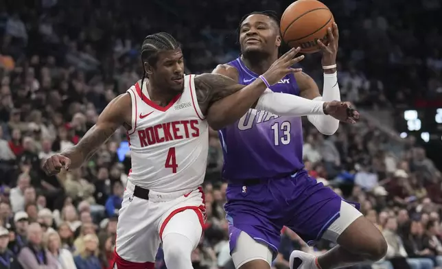Houston Rockets guard Jalen Green (4) fouls Utah Jazz guard Isaiah Collier (13) during the first half of an NBA basketball game Saturday, Feb. 22, 2025, in Salt Lake City. (AP Photo/Bethany Baker)