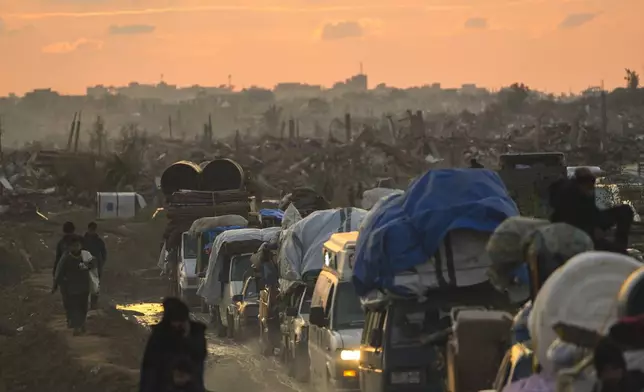 Displaced Palestinians, traveling in vehicles, wait in line to pass through a security checkpoint at the Netzarim corridor as they make their way from central Gaza to their homes in the northern Gaza Strip, Monday, Feb. 10, 2025. (AP Photo/Abdel Kareem Hana)