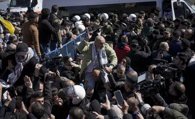 Palestinian prisoners are greeted after being released from Israeli prison following a ceasefire agreement between Israel and Hamas, in the West Bank city of Ramallah, Saturday, Feb. 15, 2025. (AP Photo/Mahmoud Illean)