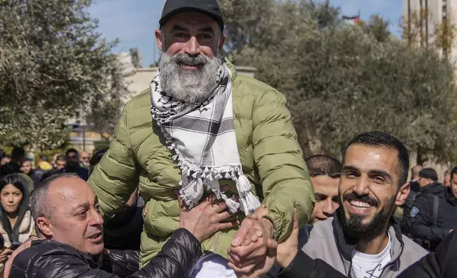Palestinian prisoner Hassan Awis, center, is greeted after being released from Israeli prison following a ceasefire agreement between Israel and Hamas, in the West Bank city of Ramallah, Saturday, Feb. 15, 2025. (AP Photo/Nasser Nasser)