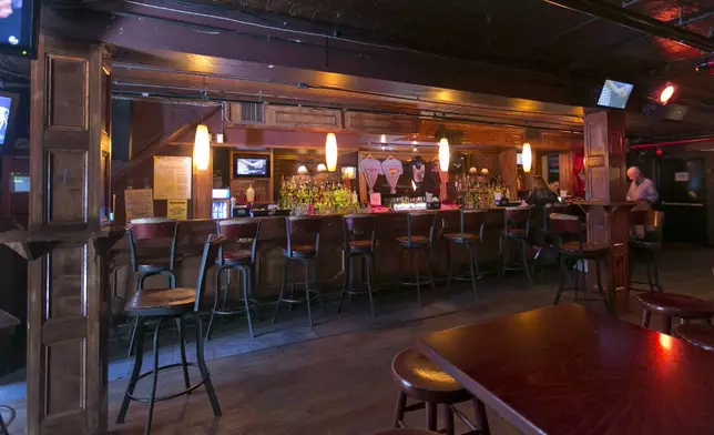 FILE - Patrons sit at the bar in The Stonewall Inn, in New York's Greenwich Village, Thursday, May 29, 2014. (AP Photo/Richard Drew, File)