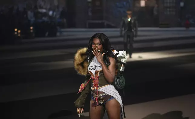 A model wears a creation as part of the Dsquared2 Fall/Winter 2025-2026 men's and women's collection presented in Milan, Italy, Tuesday, Feb. 25, 2025. (AP Photo/Antonio Calanni)