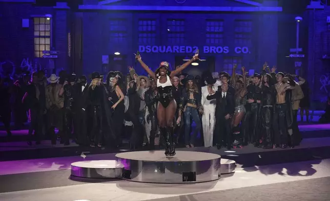 Doechii (front) performs after the Dsquared2 Fall/Winter 2025-2026 men's and women's collection presented in Milan, Italy, Tuesday, Feb. 25, 2025. (AP Photo/Antonio Calanni)