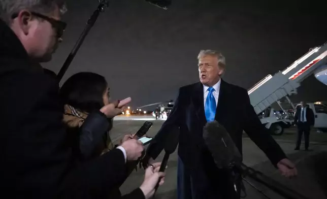 President Donald Trump speaks to reporters next to Air Force One after arriving back at Joint Base Andrews, Md., Sunday, Feb. 2, 2025. (AP Photo/Ben Curtis)