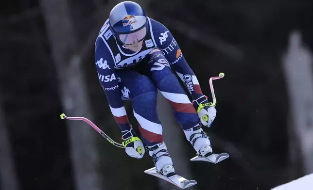 United States' Lindsey Vonn speeds down the course during an alpine ski, women's World Cup downhill, in Garmisch, Germany, Saturday, Jan. 25, 2025. (AP Photo/Giovanni Maria Pizzato)