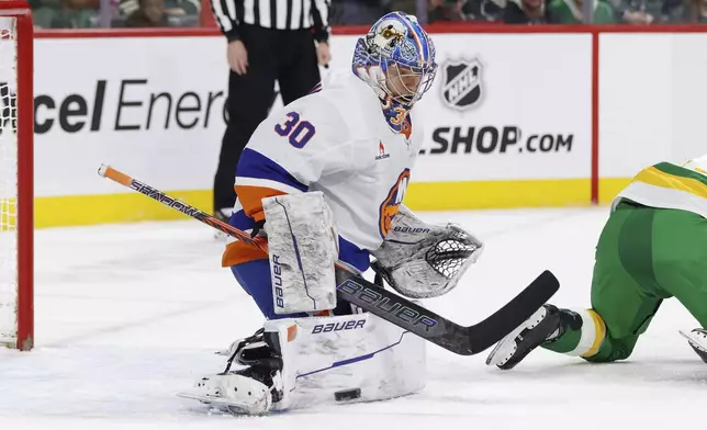 New York Islanders goaltender Ilya Sorokin (30) makes a save during the first period of an NHL hockey game against the Minnesota Wild, Saturday, Feb. 8, 2025, in St. Paul, Minn. (AP Photo/Bailey Hillesheim)