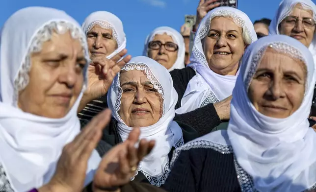 Kurdish women gather to watch live on a tv screen a Pro-Kurdish Peoples' Equality and Democracy Party, or DEM, delegation members releasing an statement from the jailed leader of the rebel Kurdistan Workers' Party, or PKK, Abdullah Ocalan, in Diyarbakir, Turkey, Thursday, Feb. 27, 2025. (AP Photo/Metin Yoksu)