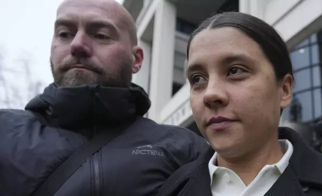 Chelsea and Australia soccer player Samantha Kerr, right, departs Kingston Crown Court, in south west London, Tuesday, Feb. 11, 2025, where she is was found not guilty on charges of alleged racially aggravated harassment of a police officer. (AP Photo/Kin Cheung)