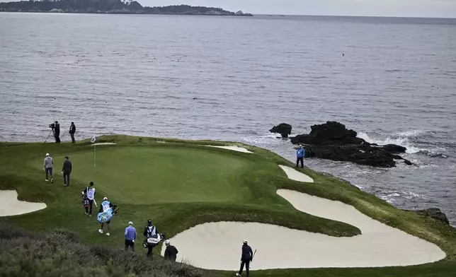 Jordan Spieth, far left, leads his group to the seventh green at Pebble Beach Golf Links during the second round of the AT&amp;T Pebble Beach Pro-Am golf tournament, Friday, Jan. 31, 2025, in Pebble Beach, Calif. (AP Photo/Nic Coury)