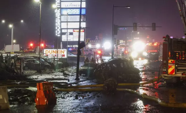 The scene near Roosevelt Boulevard after a small plane crashed near Roosevelt Mall, Friday, Jan. 31, 2025, in Philadelphia. (Steven M. Falk/The Philadelphia Inquirer via AP)