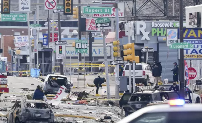 Investigators work the scene after a small plane crashed in Philadelphia, Saturday, Feb. 1, 2025. (AP Photo/Matt Rourke)