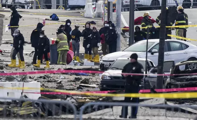 Investigators work the scene after a small plane crashed in Philadelphia, Saturday, Feb. 1, 2025. (AP Photo/Matt Rourke)