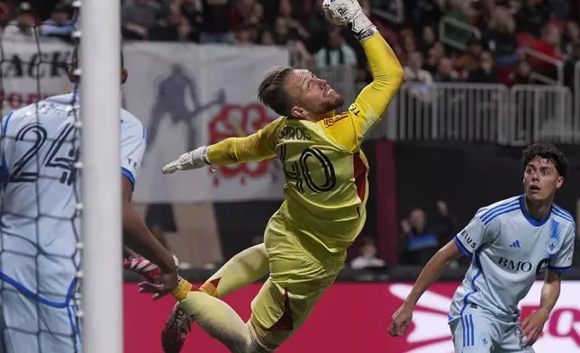 CF Montreal goalkeeper Jonathan Sirois (40) deflects an Atlanta United shot on goal during the first half of an MLS soccer game, Saturday, Feb. 22, 2025, in Atlanta. (AP Photo/Mike Stewart)