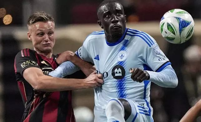 Atlanta United defender Stian Gregersen, left, and CF Montreal forward Prince Osei Owusu, right, vie for the ball during the first half of an MLS soccer game, Saturday, Feb. 22, 2025, in Atlanta. (AP Photo/Mike Stewart)