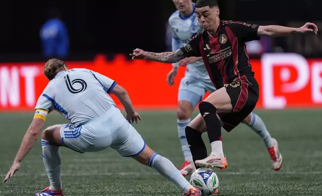 Atlanta United midfielder Miguel Almirón, front right, moves the ball against CF Montreal midfielder Samuel Piette (6) during the first half of an MLS soccer game, Saturday, Feb. 22, 2025, in Atlanta. (AP Photo/Mike Stewart)