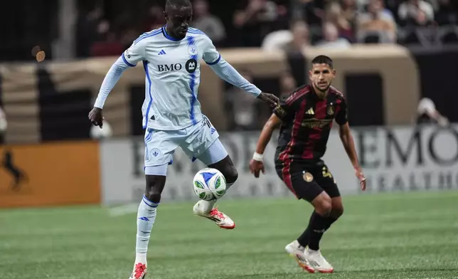 CF Montreal forward Prince Osei Owusu, left, moves the ball against Atlanta United defender Luis Abram, right, during the first half of an MLS soccer game, Saturday, Feb. 22, 2025, in Atlanta. (AP Photo/Mike Stewart)