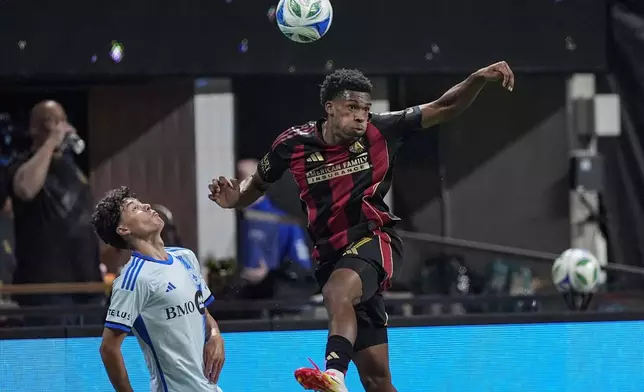 Atlanta United defender Matthew Edwards, right, kicks the ball against CF Montreal midfielder Caden Clark, left, during the first half of an MLS soccer game, Saturday, Feb. 22, 2025, in Atlanta. (AP Photo/Mike Stewart)
